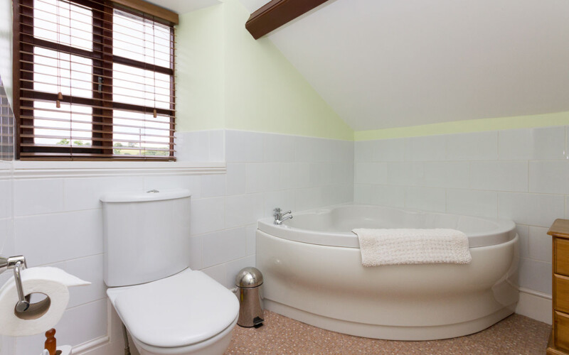 Harford House Family Bathroom Family bathroom on first floor with sloping ceiling above bath to 3ft (90cm)above floor.