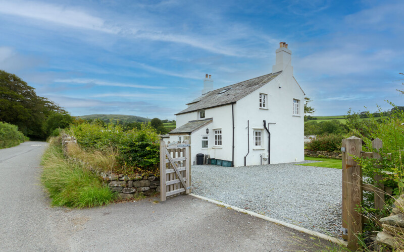 Harford House from lane to Peter Tavy Village Cottage as seen from the lane to Peter Tavy.  Shows level gravel area around the building and road access