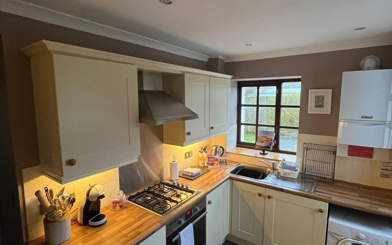 Harford House Kitchen Cooking and washing area is in an 'L' shape with window seat to right of washing machine (not in picture).  Access to dining room is to left of picture.