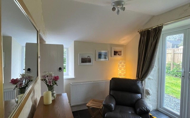 Harford House Snug The snug has good natural light from the patio doors and the window behind the recliner chair.  There is a 6in (150 mm) step up to exit through the patio doors.  The floor is otherwise level into the kitchen and lounge area.